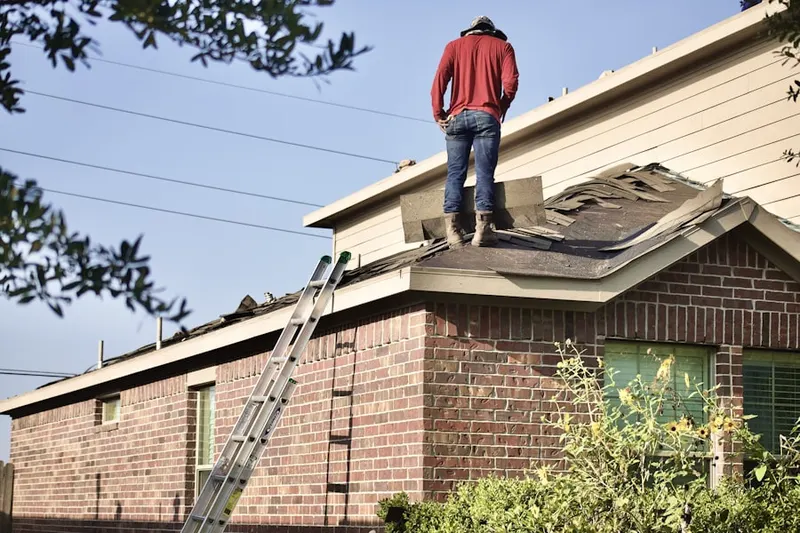 Professional roofer working on a residential roof in New Providence